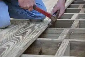 Photo of man building deck