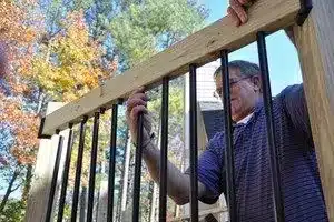 PHoto of man installing deck railing