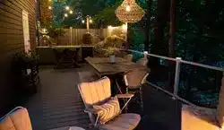 Photo of a deck at night with string lights