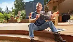 photo of a man sitting on a deck
