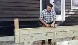 photo of a man building a deck