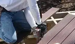 photo of man working on a deck