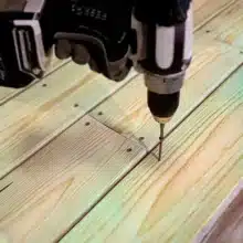 Photo of wood screw being drilled into board
