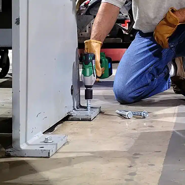 Photo of concrete screws being drilled into concrete