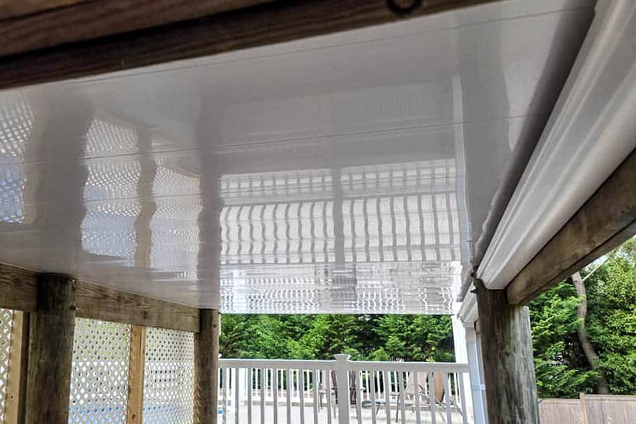 Under-deck waterproofing system installed beneath a raised deck to manage water runoff